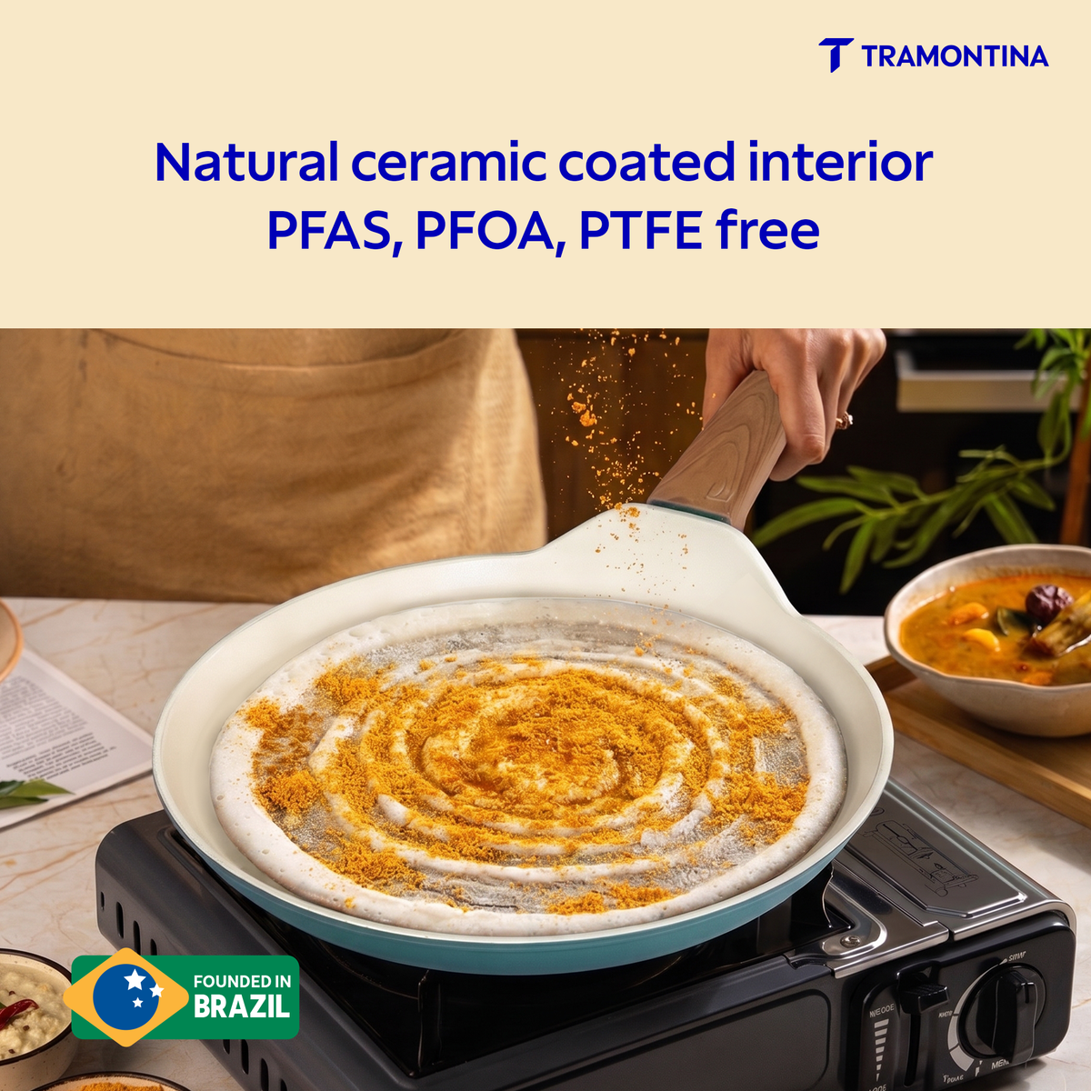 Tramontina Spectra Forged Dosa Tawa 28 cm with non-stick surface and wooden handle for easy cooking and flipping.