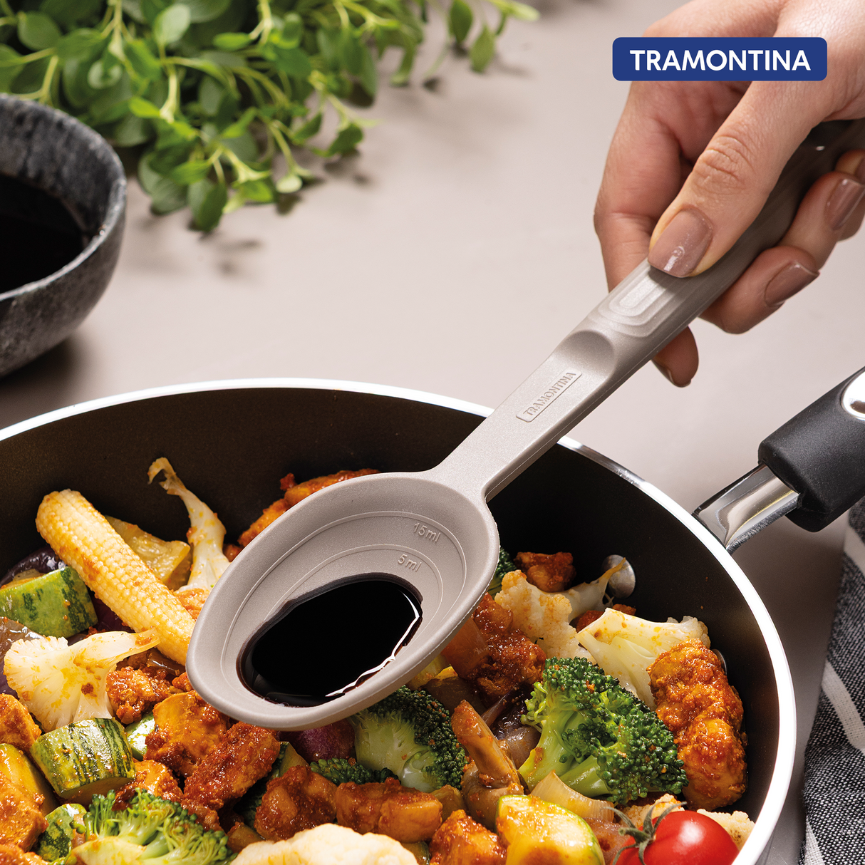 Grey Softta silicone spoon by Tramontina India with a smooth handle and flexible silicone head for cooking and serving.