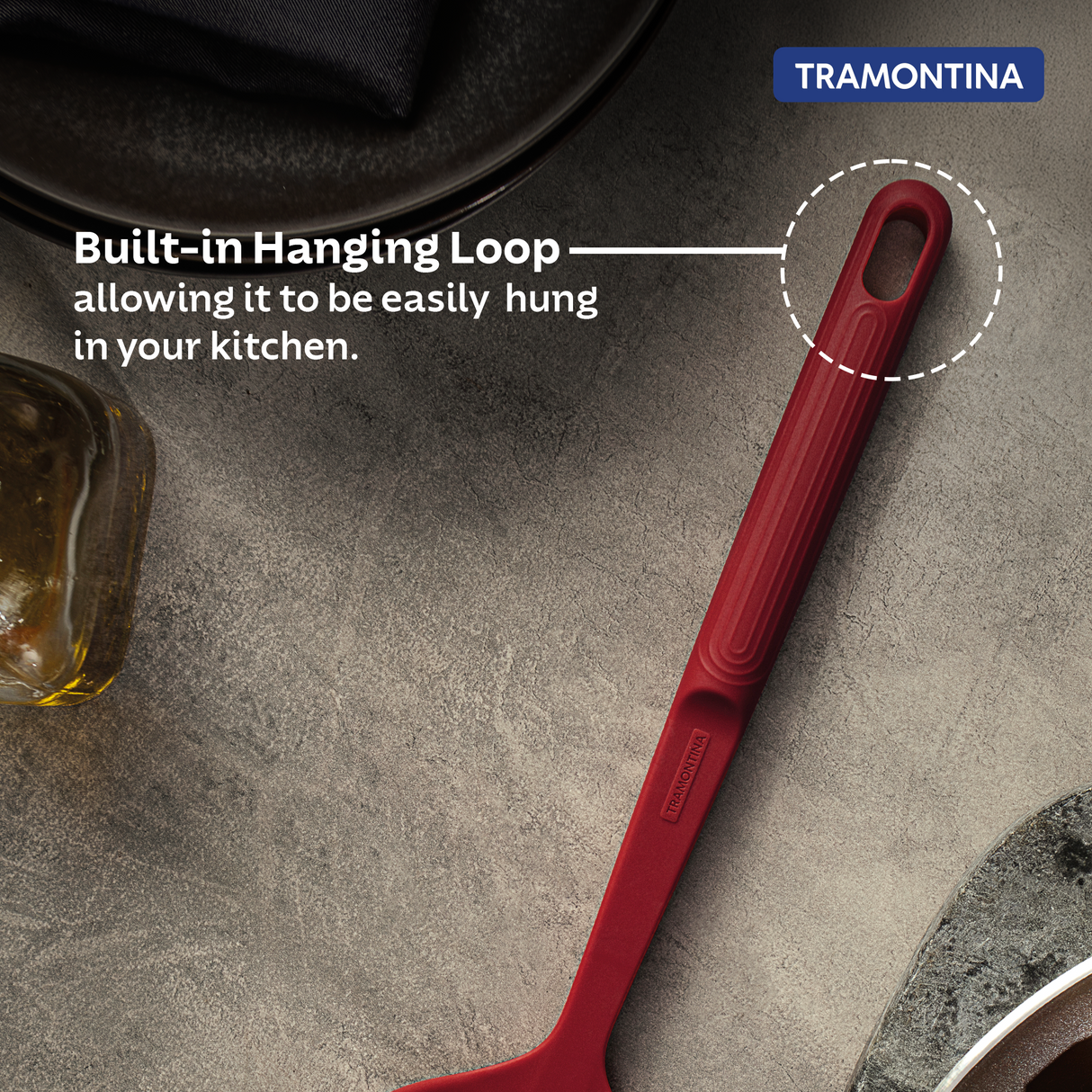 Red Softta Silicone Skimmer by Tramontina India with a wide silicone scoop and stainless steel handle for efficient cooking.