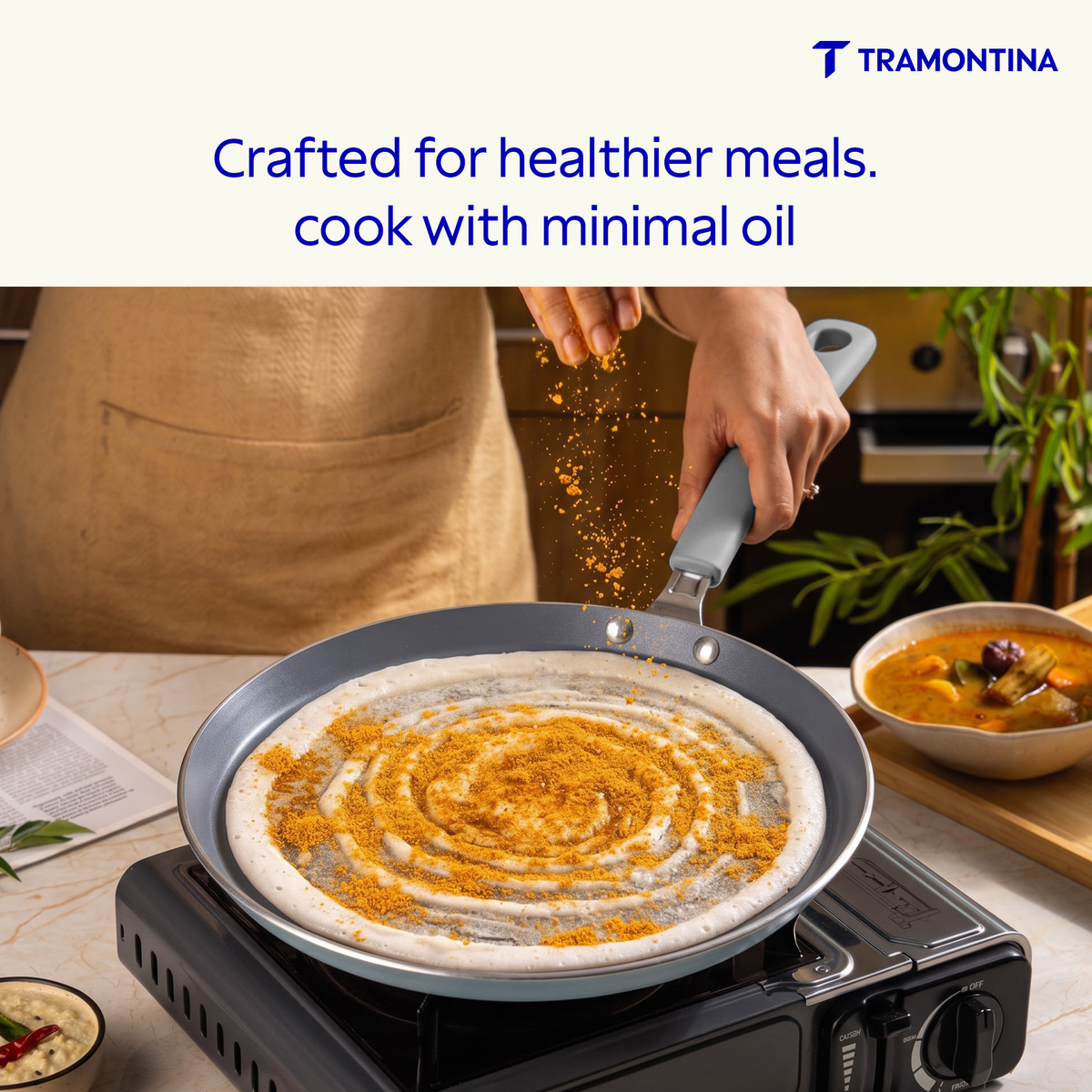 Blue Tramontina Stella Dosa Tawa 28 cm with non-stick surface, round shape, and flat cooking surface for making dosas.