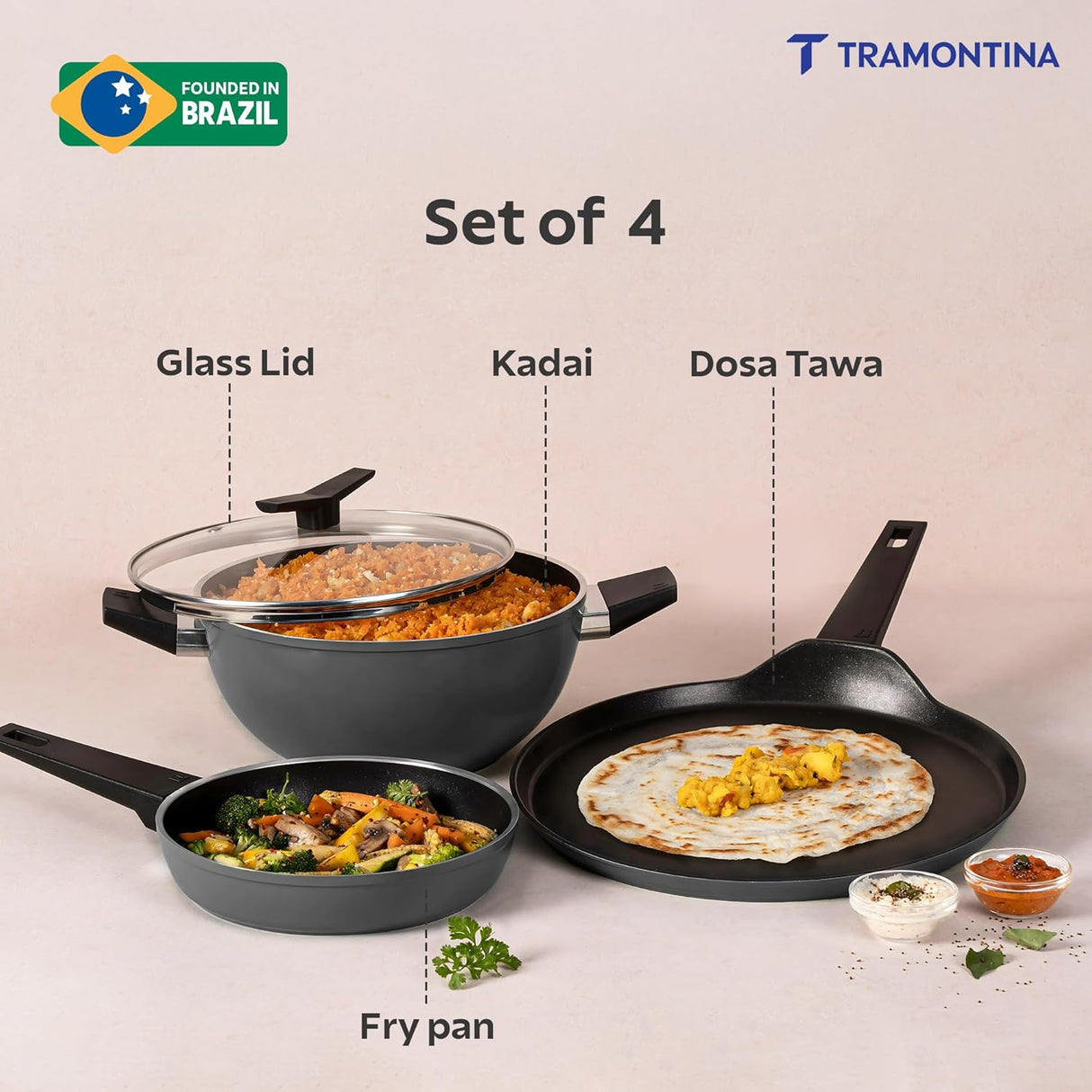 Set of four Tramontina India Chroma Forged cookware including 20cm fry pan, 28cm dosa Tawa, and 22cm Kadai in grey.