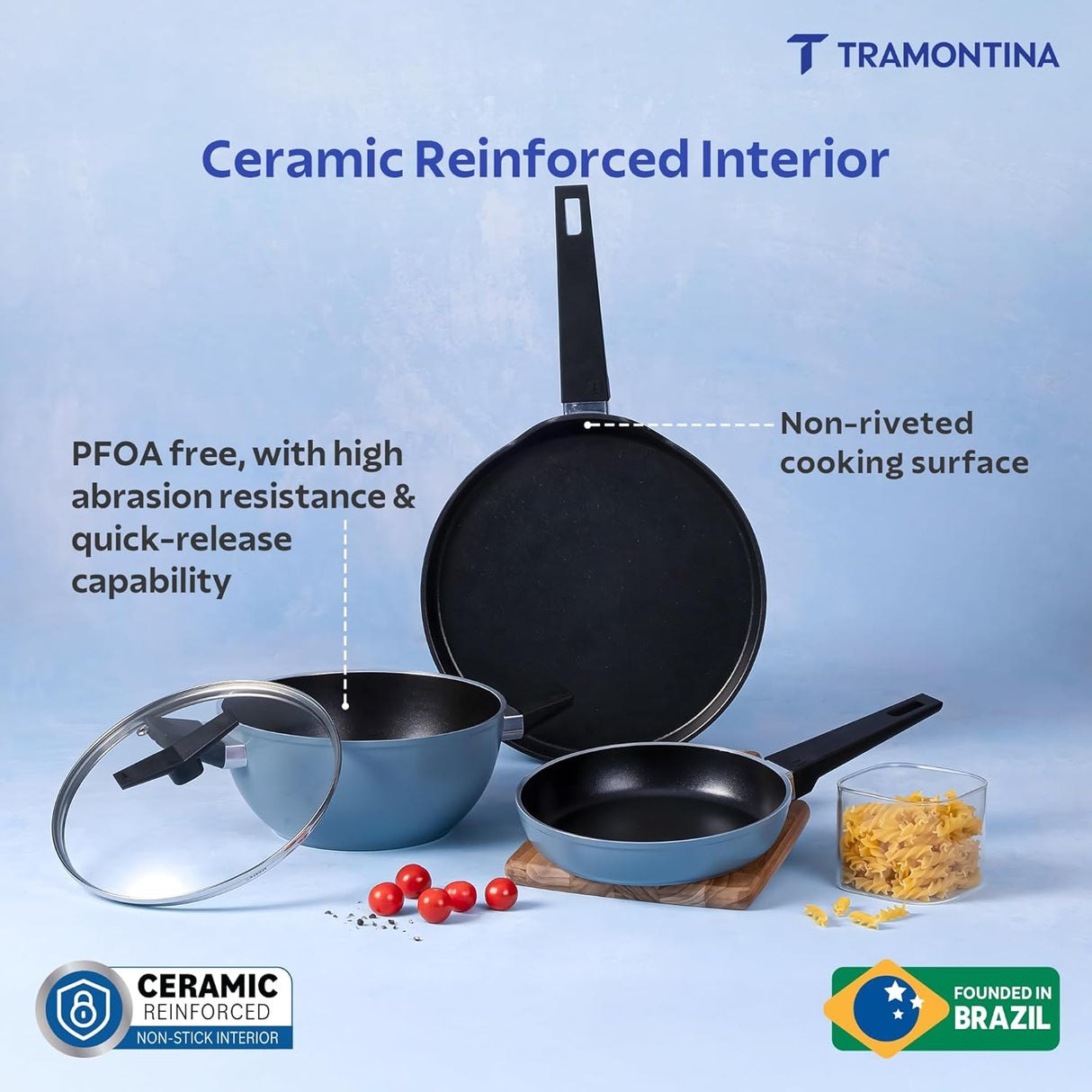 Set of four blue Tramontina India Chroma Forged cookware including 20cm fry pan, 28cm dosa tawa, and 22cm kadai.