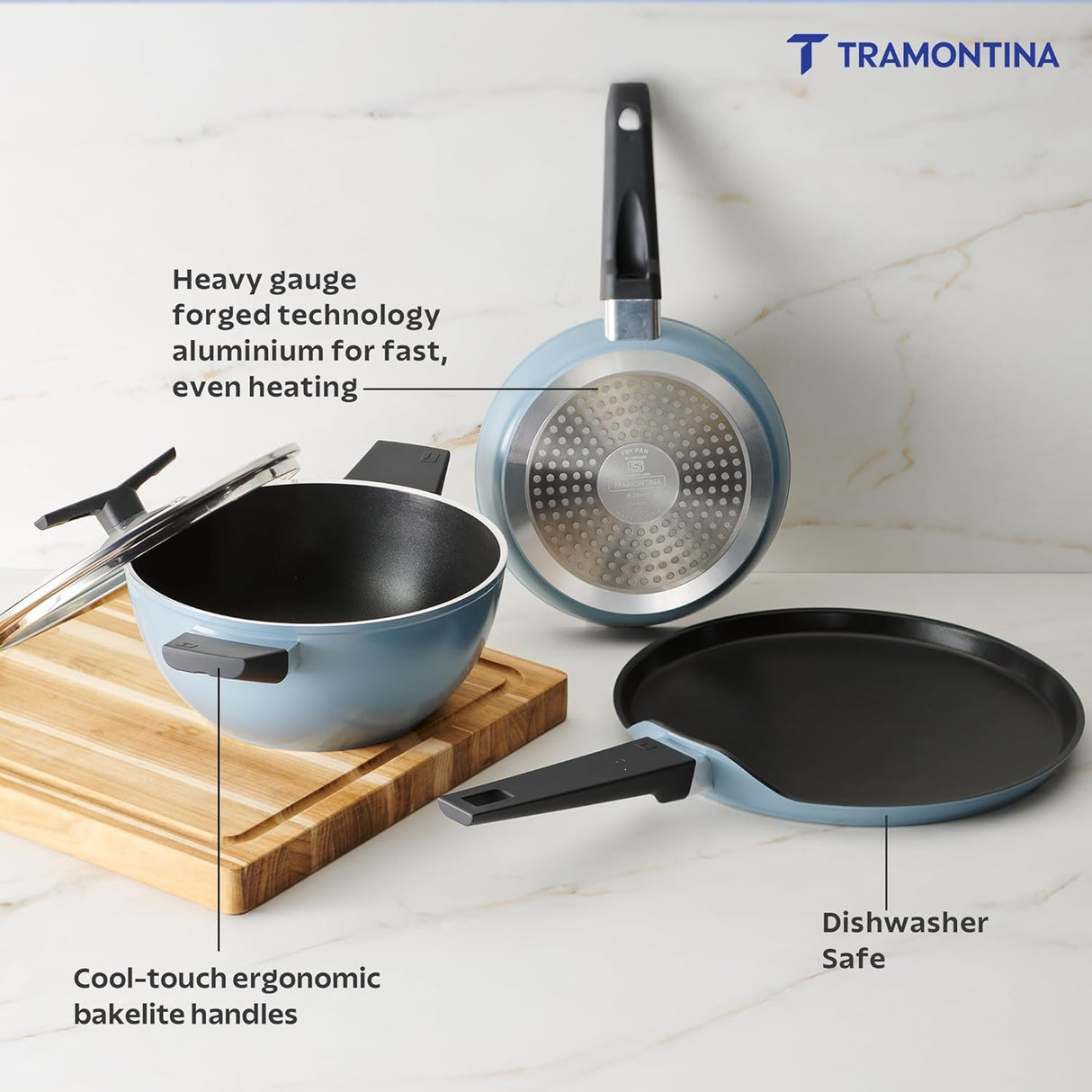 Set of four Tramontina India Chroma Forged cookware including 20cm fry pan, 28cm dosa tawa, and 22cm kadai in blue color.