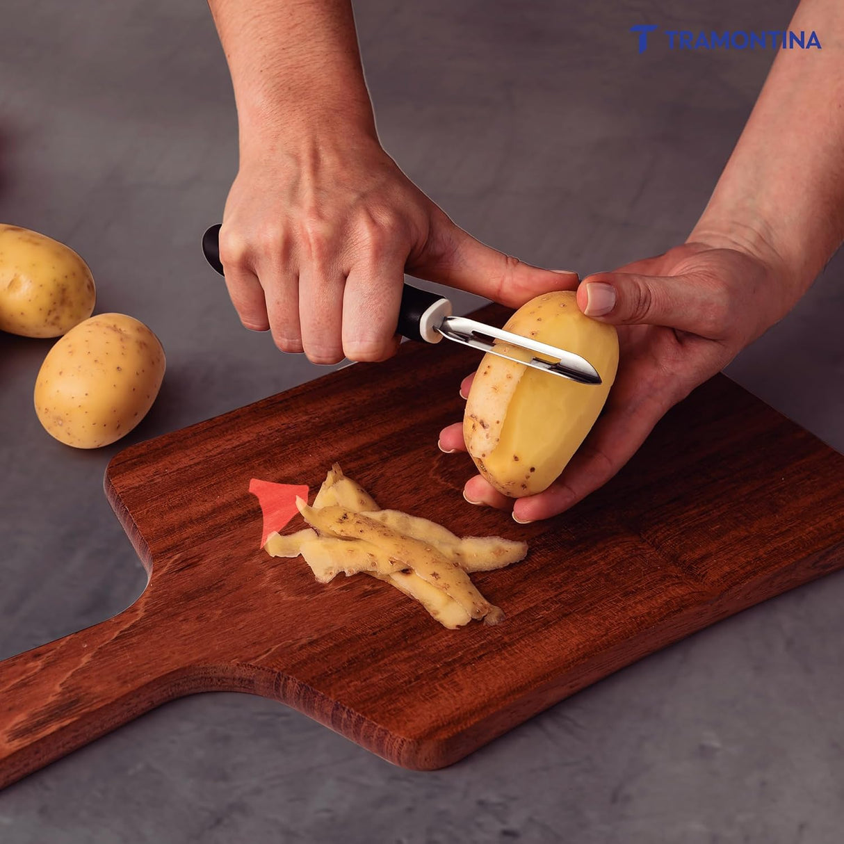 Stainless steel potato peeler from Tramontina India with ergonomic handle and sharp blade for efficient peeling.