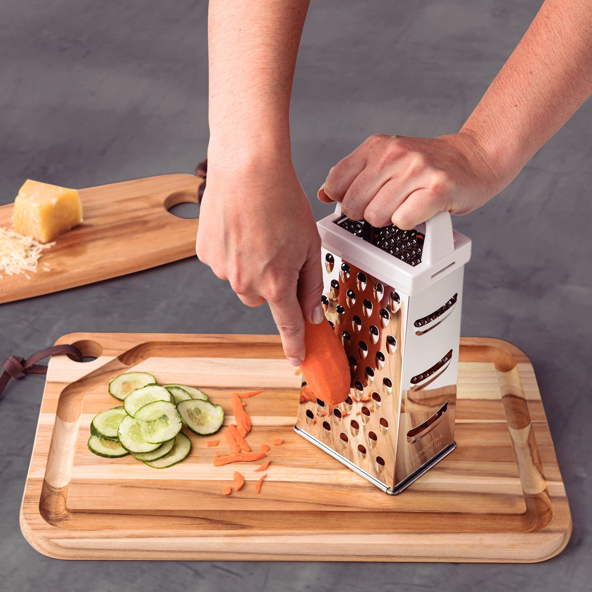 Stainless steel Utilitá 4-sided grater with white ABS handle by Tramontina India, showing multiple grating surfaces.