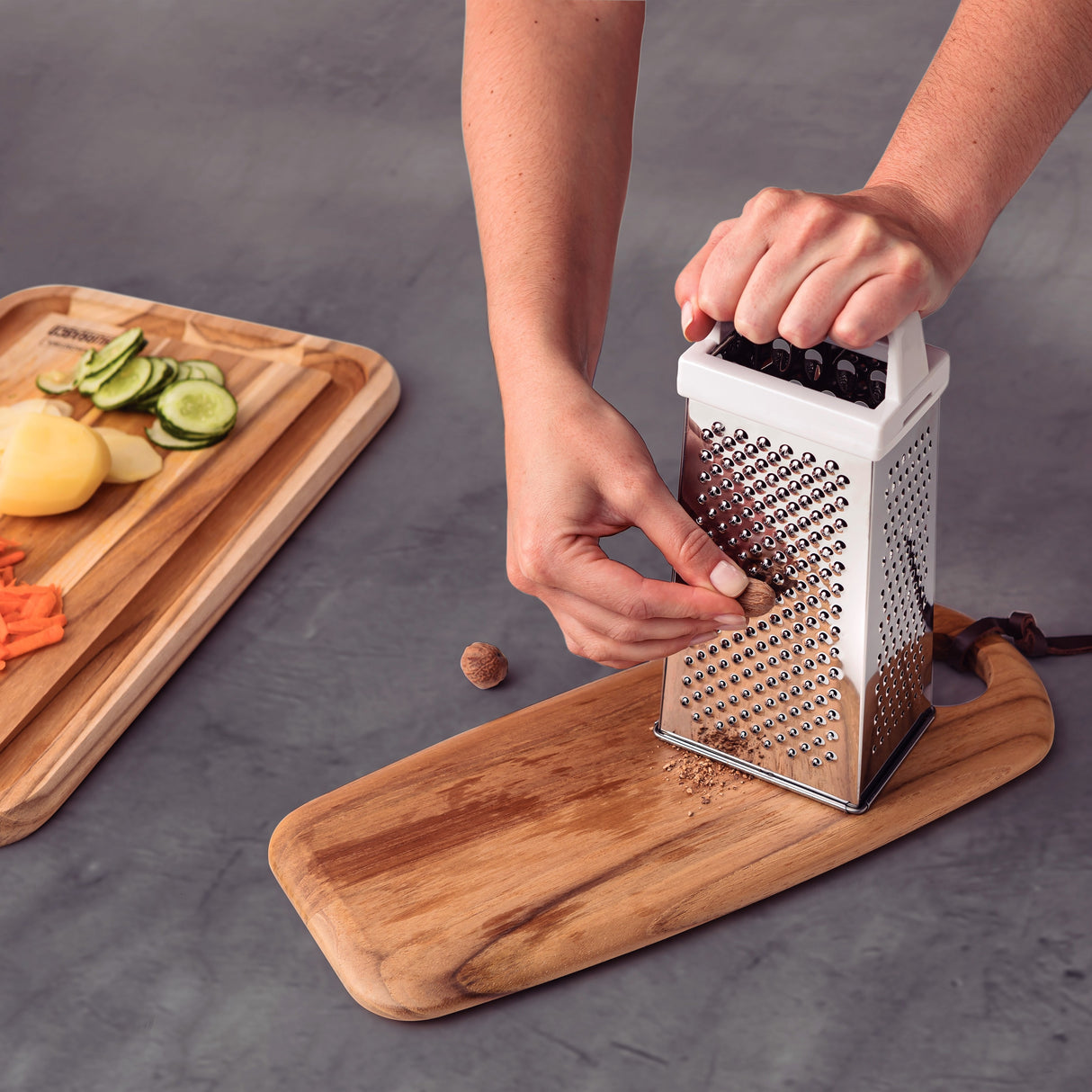 Stainless steel Utilitá 4-sided grater with white ABS handle from Tramontina India, showing different grating surfaces.