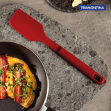 Red Softta silicone spatula by Tramontina India with a flexible silicone head and ergonomic handle, ideal for cooking and baking.