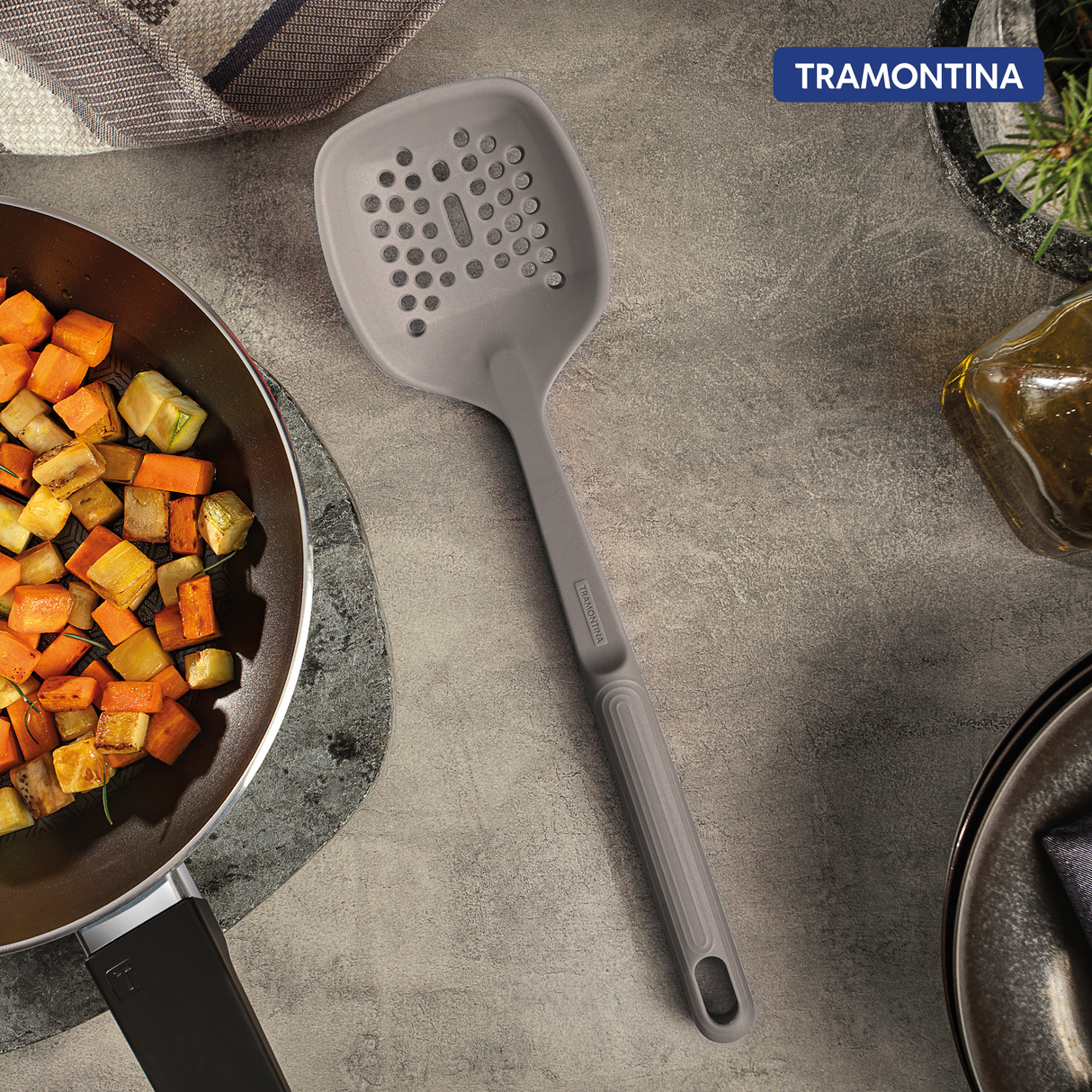 Grey Softta silicone skimmer by Tramontina India with a rounded silicone head and ergonomic handle for easy cooking and serving.