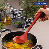 Red Softta Silicone Ladle by Tramontina India with a black handle, suitable for serving soups and stews.