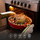 Tramontina India Bestow enameled cast iron oval Dutch oven in gradated red, 5.2L, shown with lid and sturdy handles.