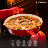 Tramontina India Bestow enameled cast iron 30cm red fry pan with a lid, showcasing a glossy red finish and sturdy handle.