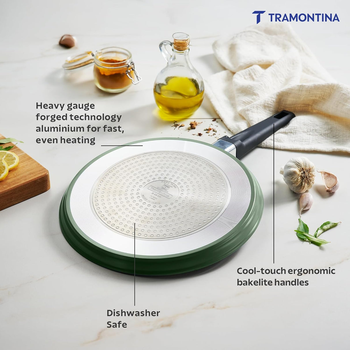 Sea green Aura 28cm non-stick ceramic-coated dosa tawa by Tramontina India, with a smooth cooking surface and reinforced coating.