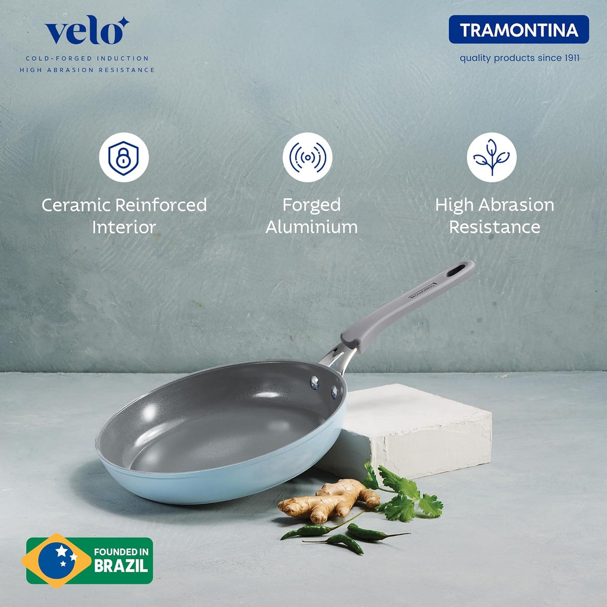 Sea-colored Tramontina India Velo Forged Fry Pan, 20 cm, with a non-stick surface and ergonomic handle, on a kitchen countertop.