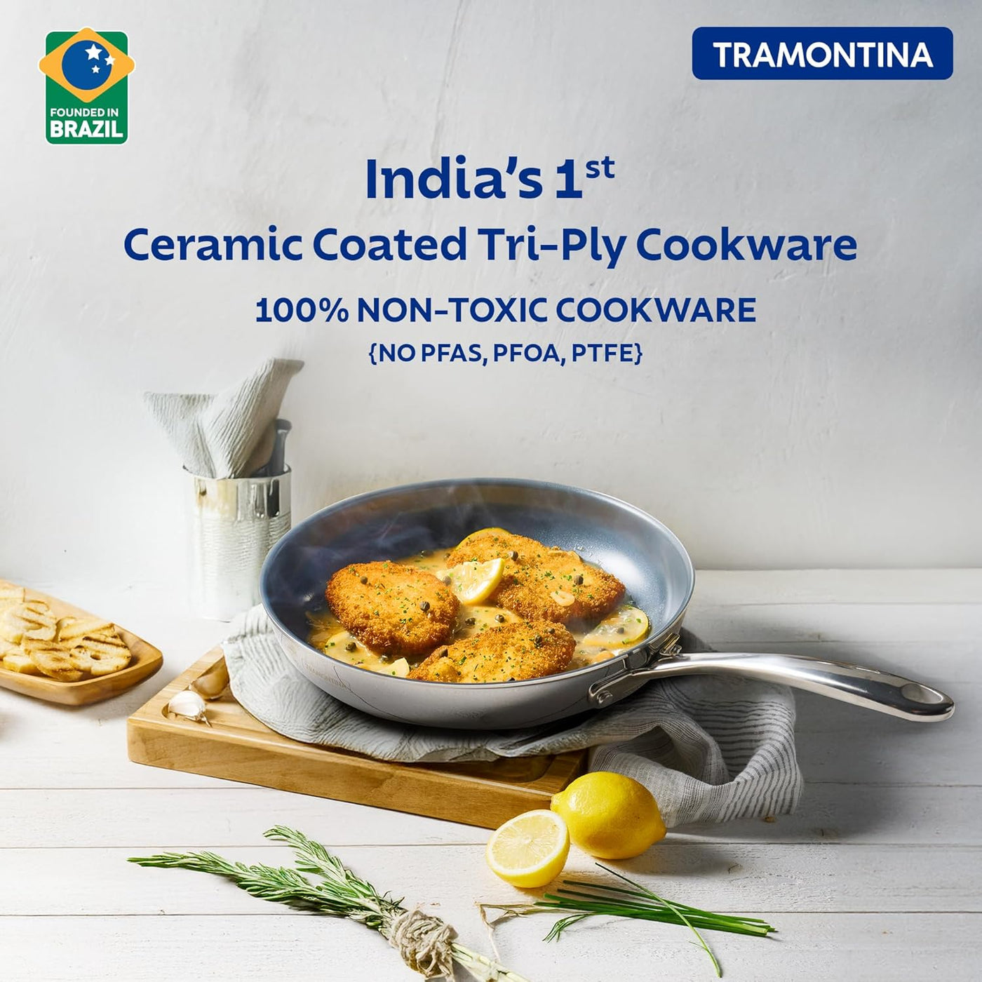 Tramontina India Fusao EX+ 24cm ceramic stainless steel tri-ply fry pan with lid on stovetop.