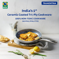 Tramontina India Fusao EX+ 24cm ceramic stainless steel tri-ply fry pan with lid on stovetop.