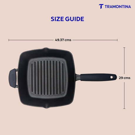 Tramontina India 27cm pre-seasoned cast iron grill pan with heat-resistant silicone grip on a wooden surface.