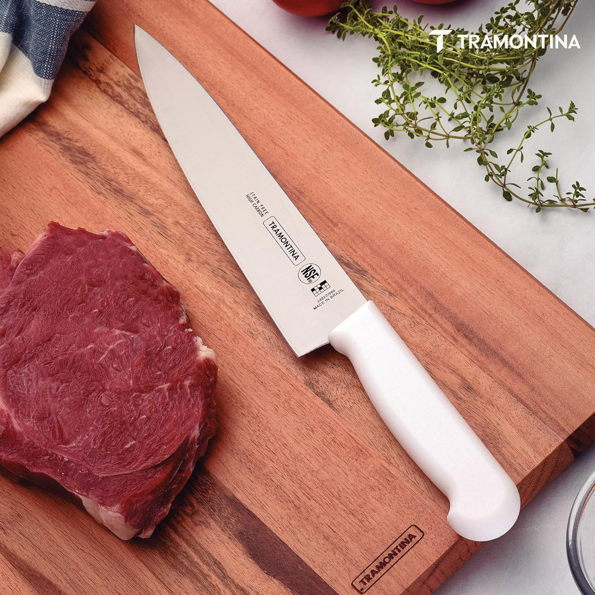 White 10-inch Tramontina India chef knife with a sharp stainless steel blade, ideal for professional meat and culinary use.