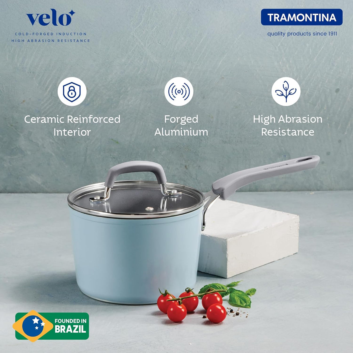16 cm Velo Forged Saucepan by Tramontina India with a stainless steel handle and blue exterior, shown on a kitchen countertop.