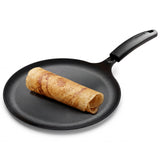 Titanex 28cm pre-seasoned cast iron dosa tawa with heat-resistant silicone grip by Tramontina India.