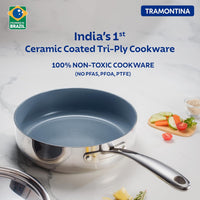 Tramontina India Fusao EX+ 24cm ceramic deep sauté pan with stainless steel lid, shown with a shiny stainless steel lid on a stovetop.