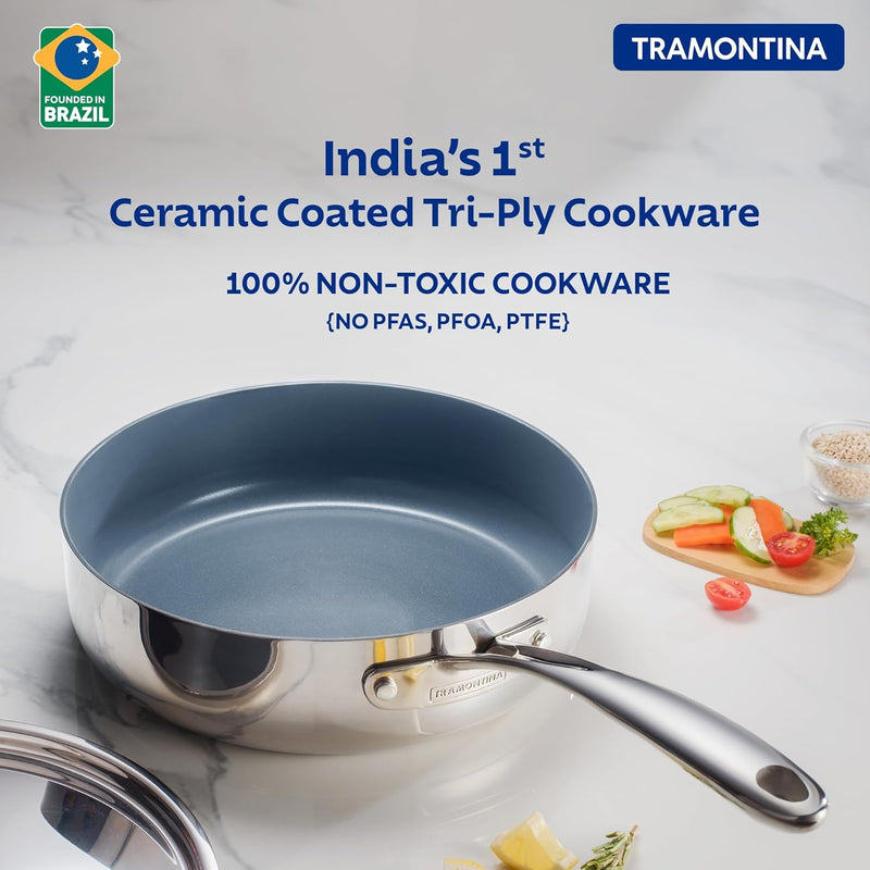 Tramontina India Fusao EX+ 24cm ceramic deep sauté pan with stainless steel lid, shown with a shiny stainless steel lid on a stovetop.