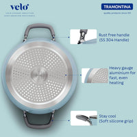 Tramontina India Velo Forged 24 cm casserole in sea green with a sturdy handle and glass lid on a kitchen countertop.