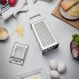 Stainless steel Utilitá 4-sided grater with white ABS handle by Tramontina India, ideal for shredding and grating in the kitchen.